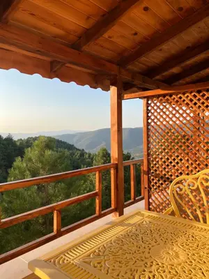 a porch with a table and a view of the mountains at Niceland İznik
