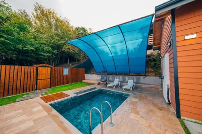 a swimming pool with a glass roof on a house at Say Resort Bungalov in Sapanca