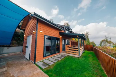 a tiny house with a porch and a fence at Say Resort Bungalov in Sapanca