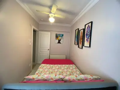 a bedroom with a bed and a ceiling fan at Kadıköy ün Kalbinde Tarihi Rahat Sessiz Daire in Istanbul