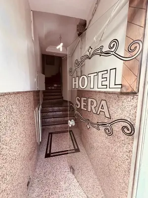 a hotel entrance with a hotel sign and stairs at Sera Hotel in Istanbul