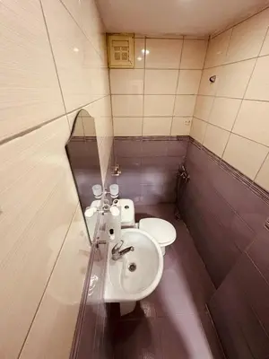 a bathroom with two toilets and a sink and a mirror at Sera Hotel in Istanbul