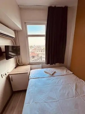 a small bedroom with a bed and a window at Sera Hotel in Istanbul