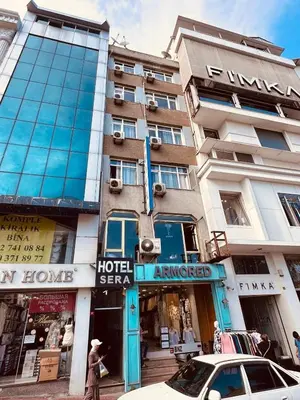 a tall building with a car parked in front of it at Sera Hotel in Istanbul