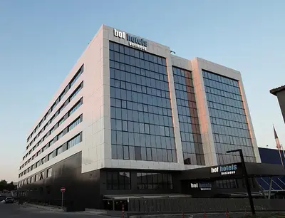 a tall white building with a lot of windows at Bof Hotels Business in Istanbul