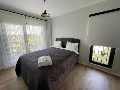 a bedroom with a bed with a pair of towels on it at Sakarya Sapanca Ünlüce de 5 oda 1 salon Özel Havuzlu Lux 10 kişilik Tatil Villası in Sapanca