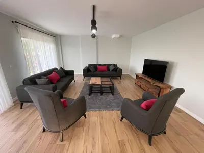a living room with couches and a flat screen tv at Sakarya Sapanca Ünlüce de 5 oda 1 salon Özel Havuzlu Lux 10 kişilik Tatil Villası in Sapanca
