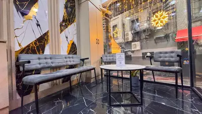 a table and chairs in a room with a window at Mar Blanco Hotel in Istanbul