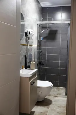 a bathroom with a toilet and a sink and a shower at Mar Blanco Hotel in Istanbul