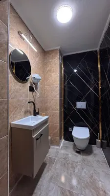 a bathroom with a toilet and a sink and a mirror at Mar Blanco Hotel in Istanbul