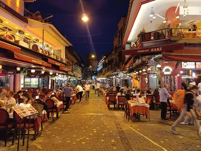 a street at night with people sitting at tables at King Mas Suit in Istanbul