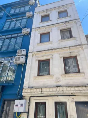 a blue and white building with windows at Taksim White House Hotel in Istanbul