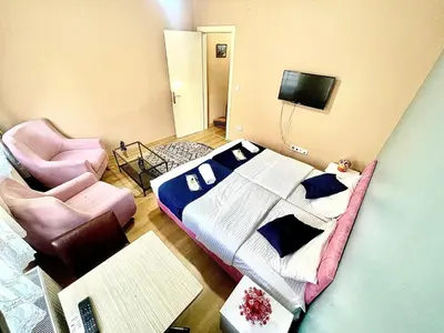 a bedroom with a bed and a chair and a tv at Taksim White House Hotel in Istanbul