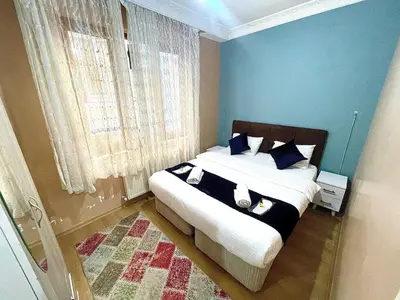 a bedroom with a large bed with blue walls at Taksim White House Hotel in Istanbul