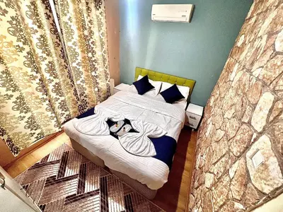 a bedroom with a bed with a woman on it at Taksim White House Hotel in Istanbul