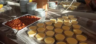 a table with cups of food and a tray ofnuts at Sare Hotel in Erdek