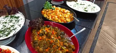 a table topped with bowls of food on a counter at Sare Hotel in Erdek