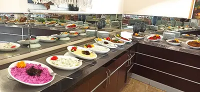 a buffet line with bowls of food in a restaurant at Sare Hotel in Erdek