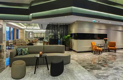 a lobby with a couch and tables and chairs at Arts Hotel Harbiye - Special Class in Istanbul