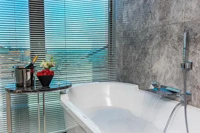 a white tub in a bathroom with a window at Arts Hotel Harbiye - Special Class in Istanbul