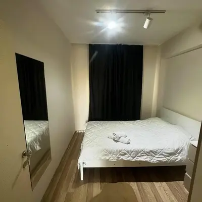 a bedroom with a white bed and a window at İstanbulhome in Istanbul