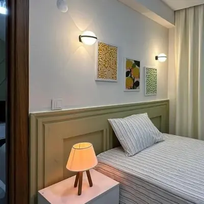 a small lamp on a table next to a bed at İstanbulhome in Istanbul