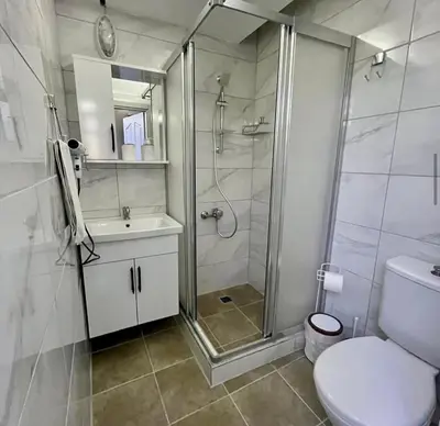 a bathroom with a shower and a toilet and a sink at İstanbulhome in Istanbul