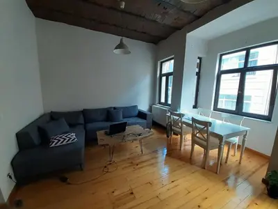 a living room with a blue couch and a table at Feridiye 3 Oda 1 salon Daire in Istanbul