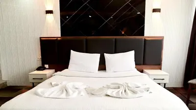 a bed with two white towels on top of it at Lizbonia Suit in Istanbul