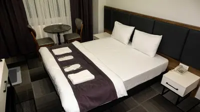 a hotel room with a bed with towels on it at Lizbonia Suit in Istanbul