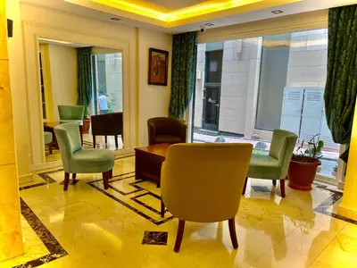 a lobby with chairs and a table and a window at PERA ARYA Hotel in Istanbul
