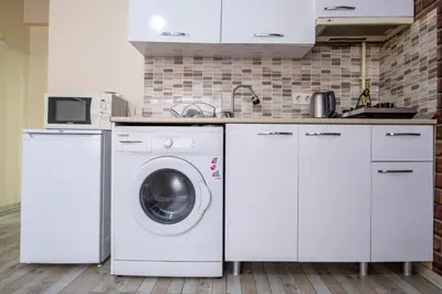 a kitchen with a washing machine and a sink at White Rose Apartments in Istanbul