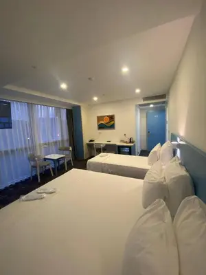 a hotel room with a large bed and a desk at No25 Hotels in Corlu