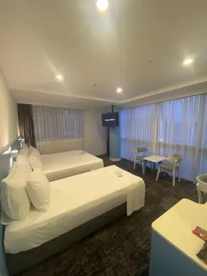 a hotel room with two beds and a television at No25 Hotels in Corlu