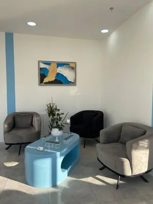 a lobby with two chairs and a table and a painting at No25 Hotels in Corlu