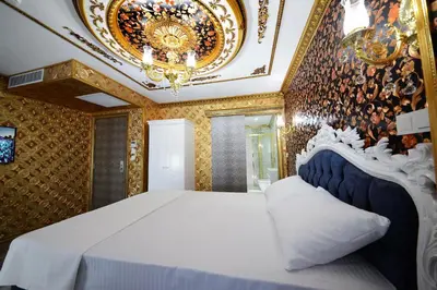 a bedroom with a large bed and a chandelier at Fatih Babel Park Hotel in Istanbul