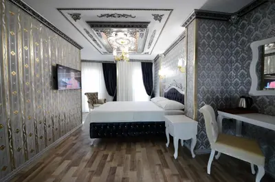 a bedroom with a bed and a chandelier at Fatih Babel Park Hotel in Istanbul