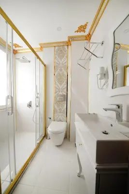 a white bathroom with a toilet and a sink at Fatih Babel Park Hotel in Istanbul