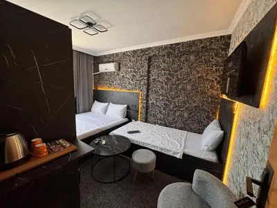 a hotel room with a bed and a table and chairs at MAHAL Otel PENDİK in Istanbul