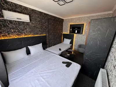 a hotel room with two beds with white sheets at MAHAL Otel PENDİK in Istanbul