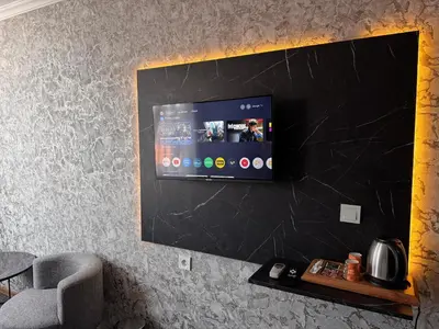 a flat screen tv hanging on a wall at MAHAL Otel PENDİK in Istanbul