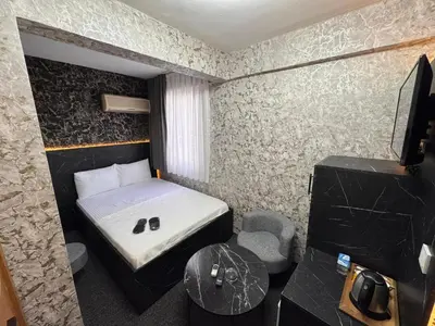 a small room with a bed and a table at MAHAL Otel PENDİK in Istanbul