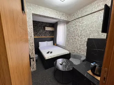 a small room with a bed and a table at MAHAL Otel PENDİK in Istanbul