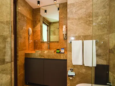 a bathroom with a sink and a toilet and a mirror at The Way Hotel in Istanbul