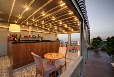 a bar on a balcony with a table and chairs at Almina Guest House in Istanbul