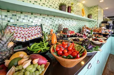 a buffet with lots of fruits and vegetables in baskets at Almina Guest House in Istanbul