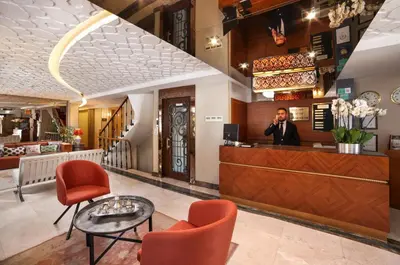 a man standing at the counter of a restaurant at Almina Guest House in Istanbul