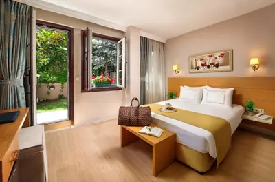 a hotel room with a large bed and a window at Almina Guest House in Istanbul