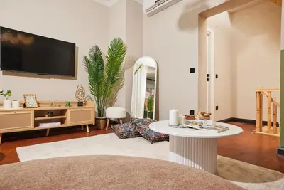 a living room with a table and a tv on the wall at Private House near Taksim in Istanbul