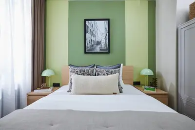 a bedroom with a large bed with green walls at Private House near Taksim in Istanbul